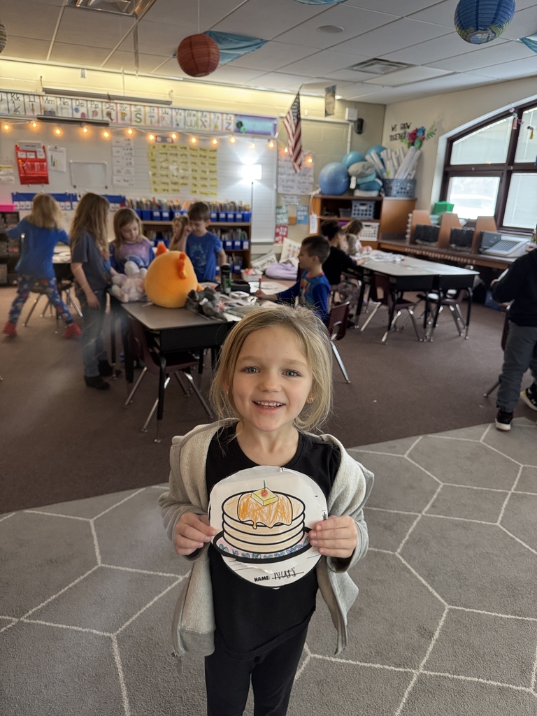 little girl holding picture of mini pancakes