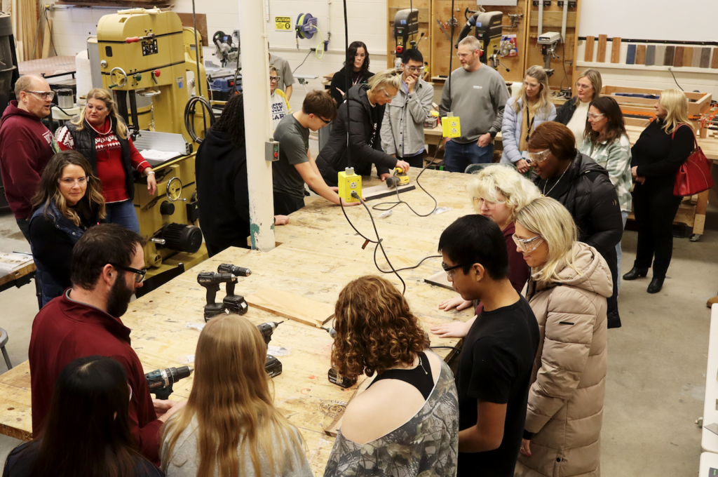students and counselors in woodshop working