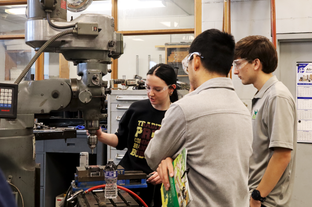 counselors watching student work machine