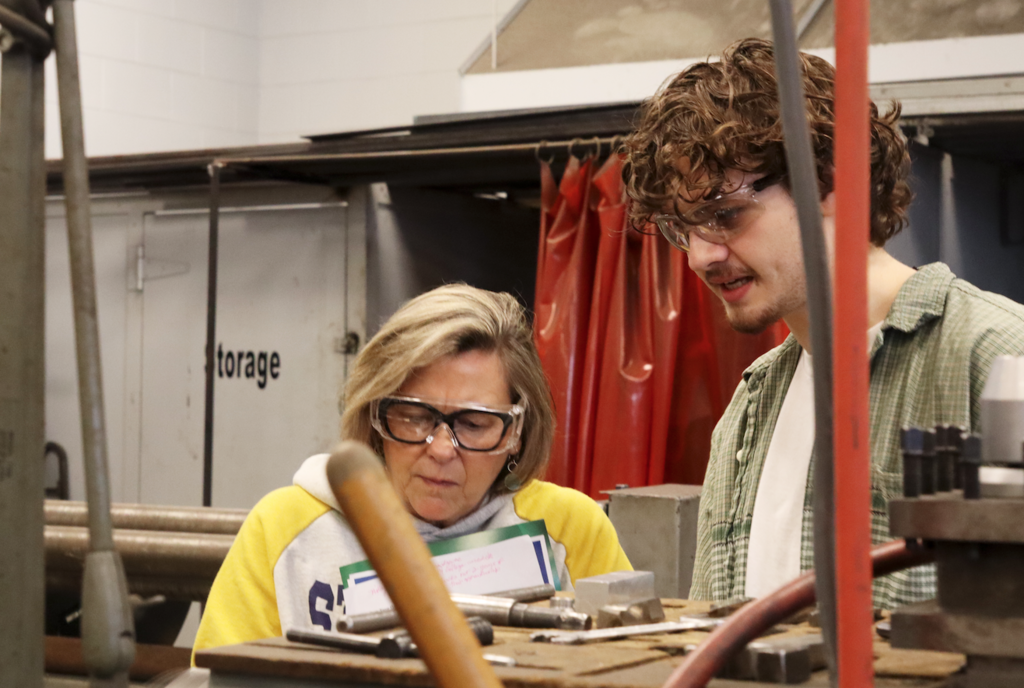 counselor and student talking about machine