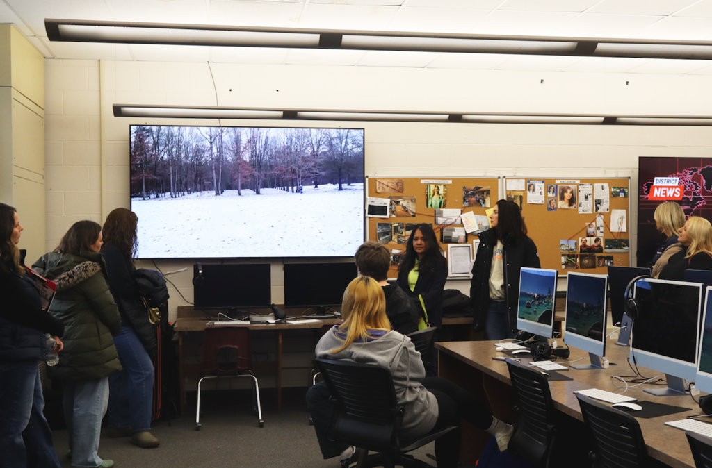 people watching a broadcast screen