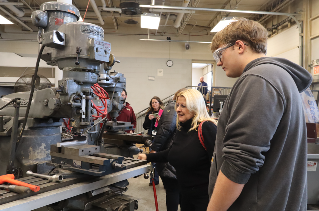 student showing counselor how machine works