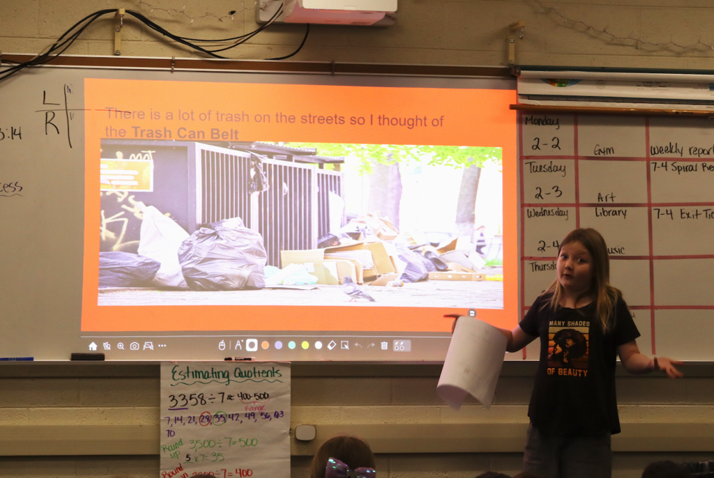 young girl presenting trash can belt