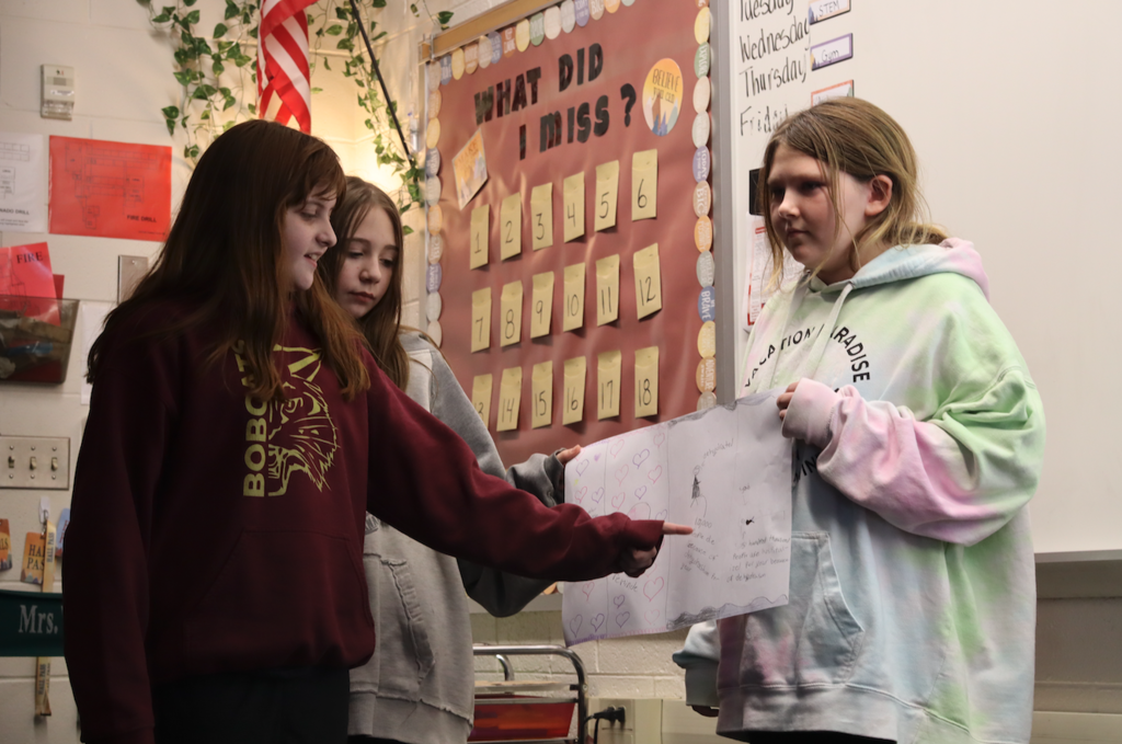 three girls showing diagram