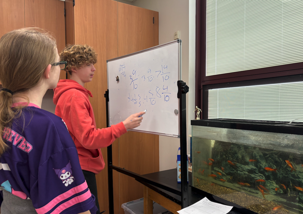young man writing on whiteboard