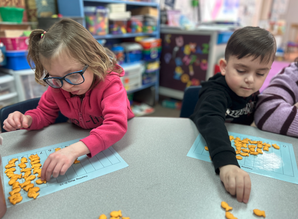 a little boy and a little girl counting fish