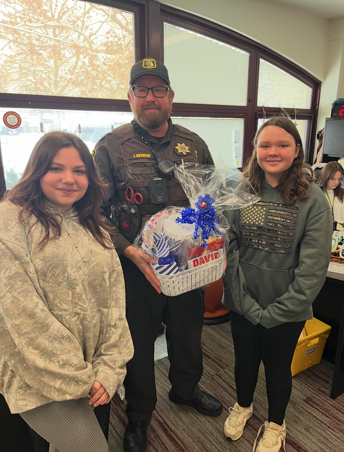 deputy duthler with two young students