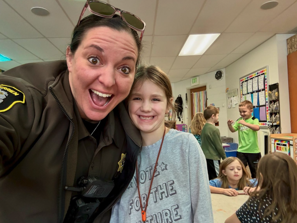 deputy mcg with young girl