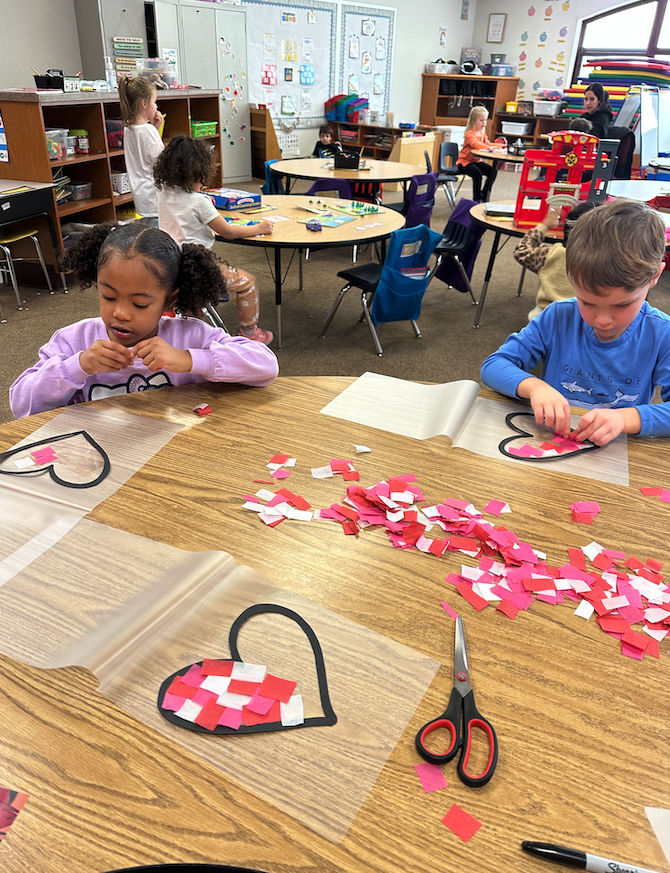 little girl and little boy making heart sun catcher