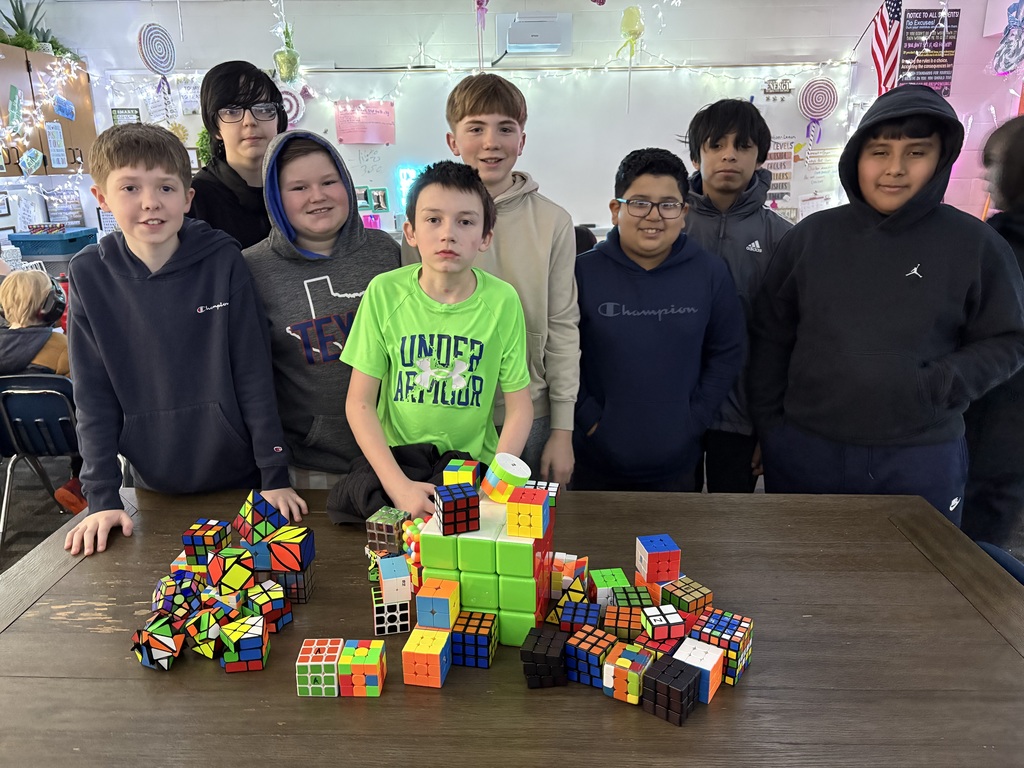 group of boys in class with rubic's cubes