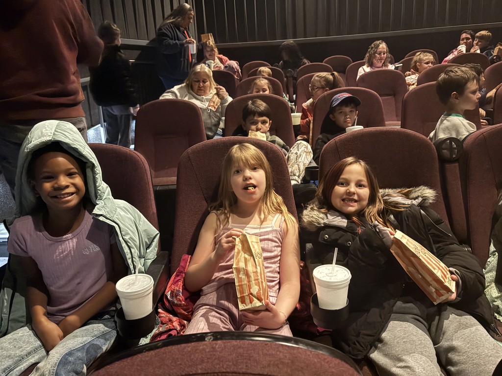 three little girls at movie theater