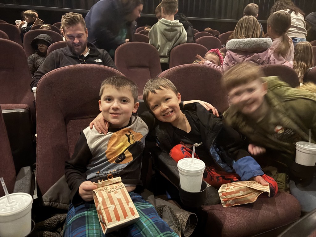 three little boys at movie theater