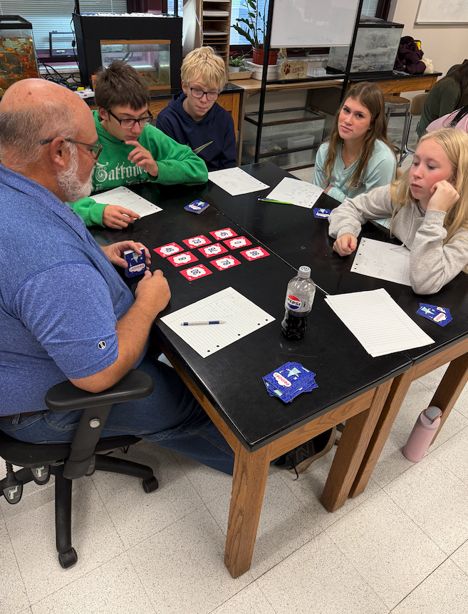 teacher with students playing math game