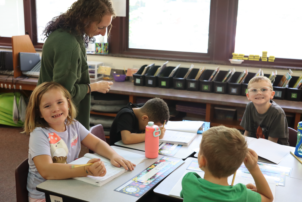 students sitting at desk writing in books