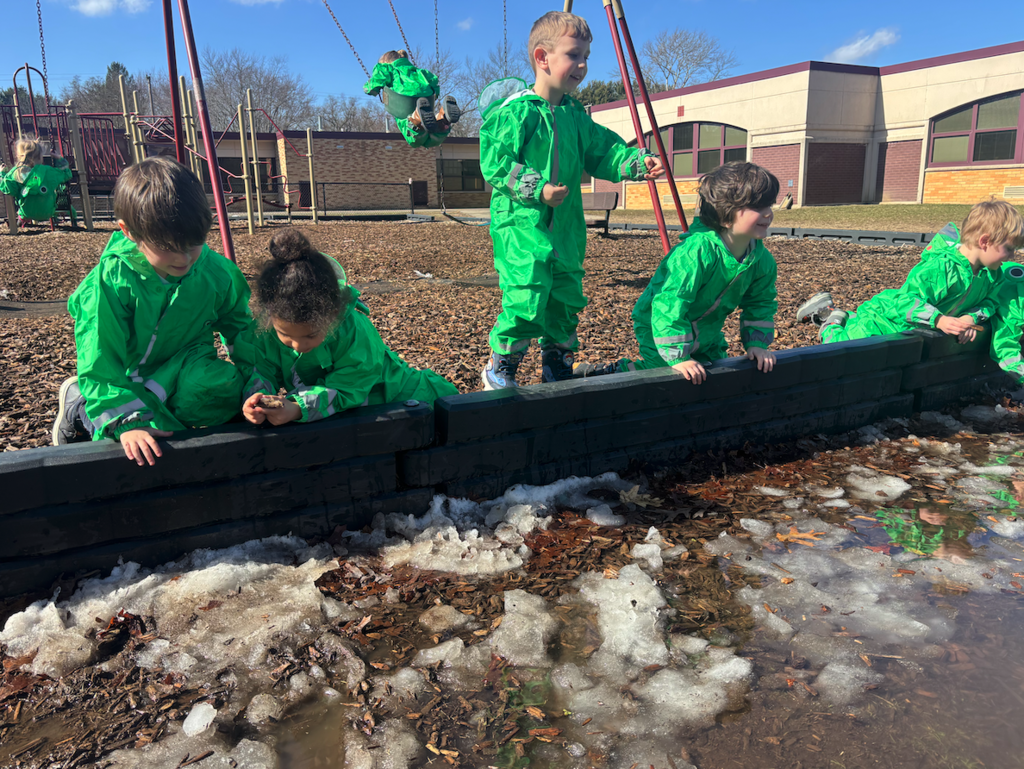 kids looking at water in froggy outfits