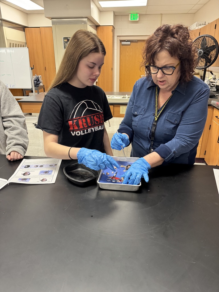 teacher helping student in science class