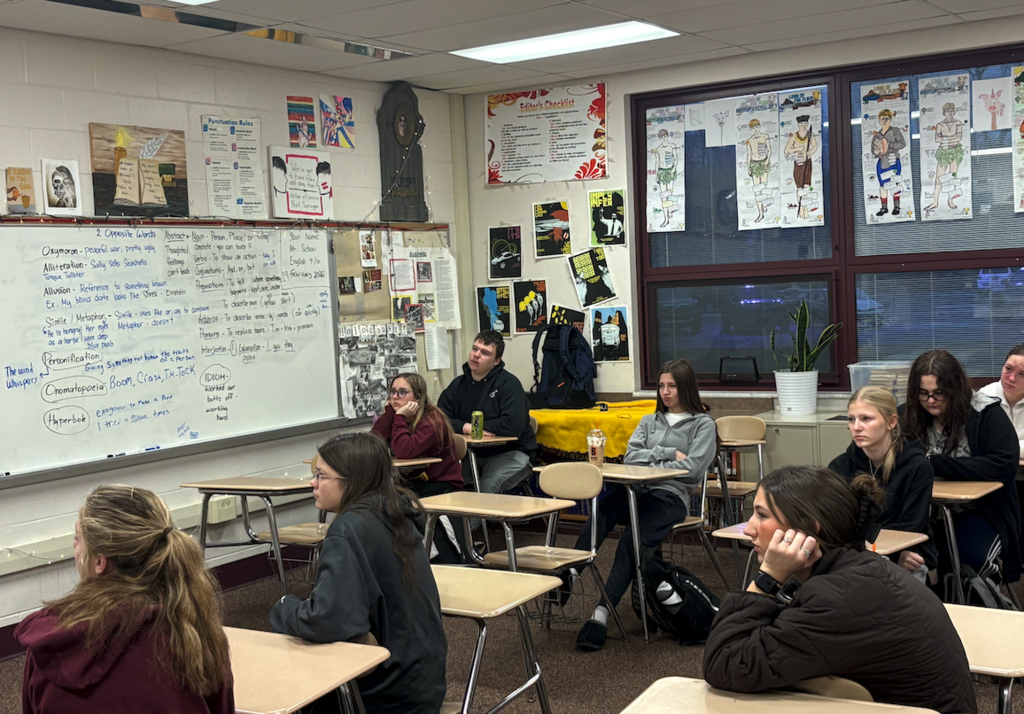 students in class listening to speaker