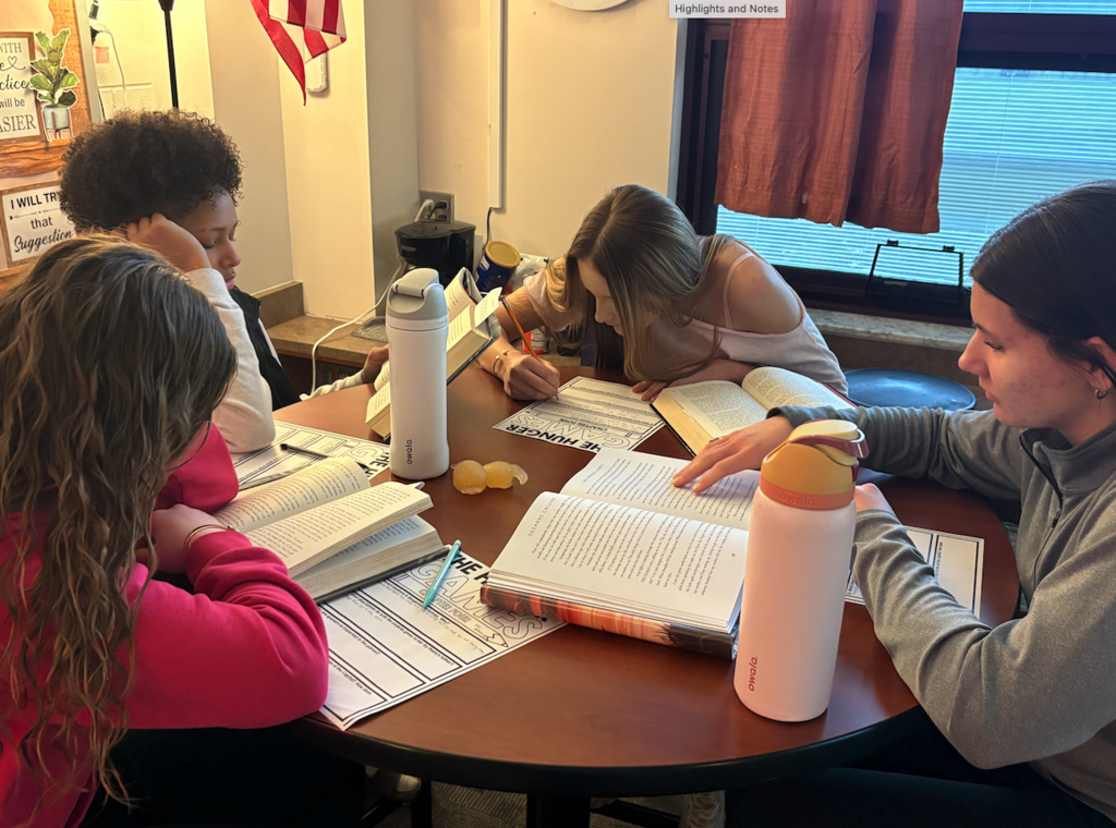 students reading books at table