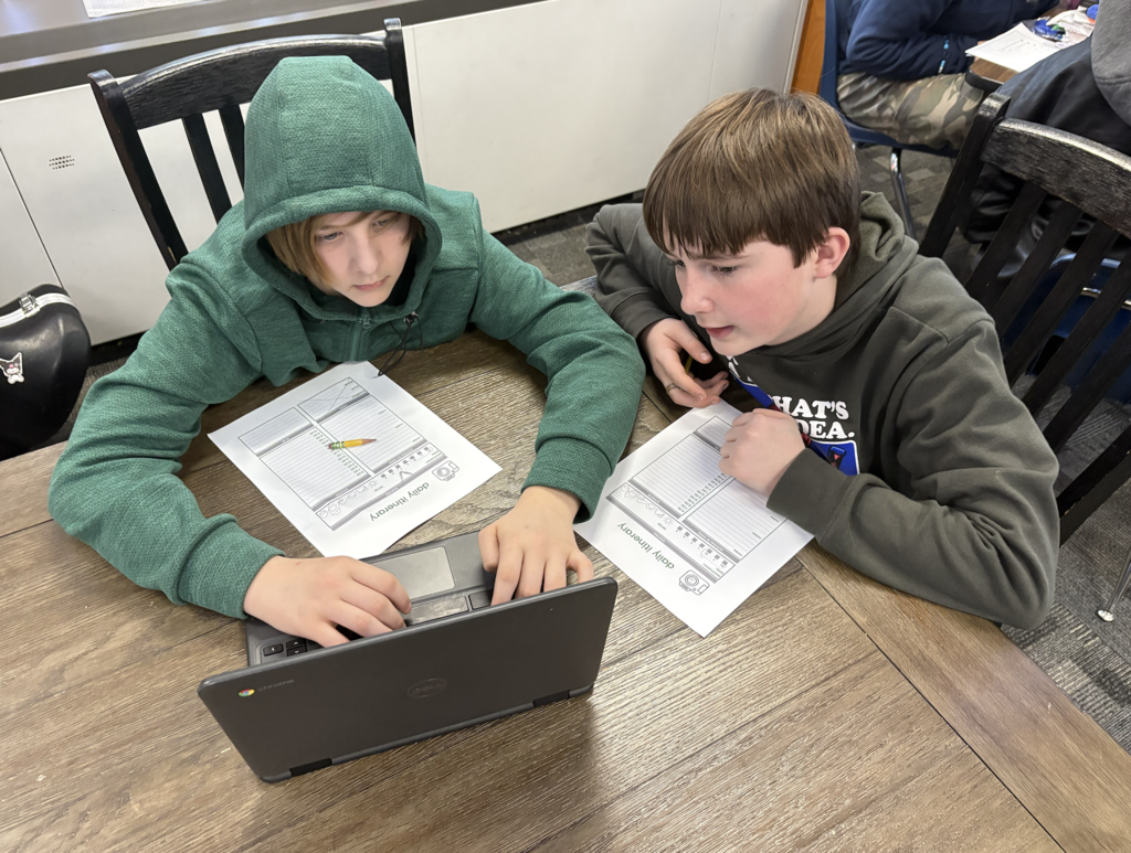 students looking at computer