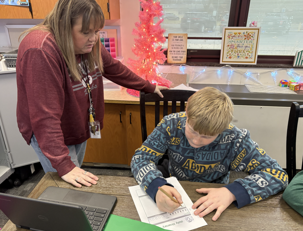teacher helping student