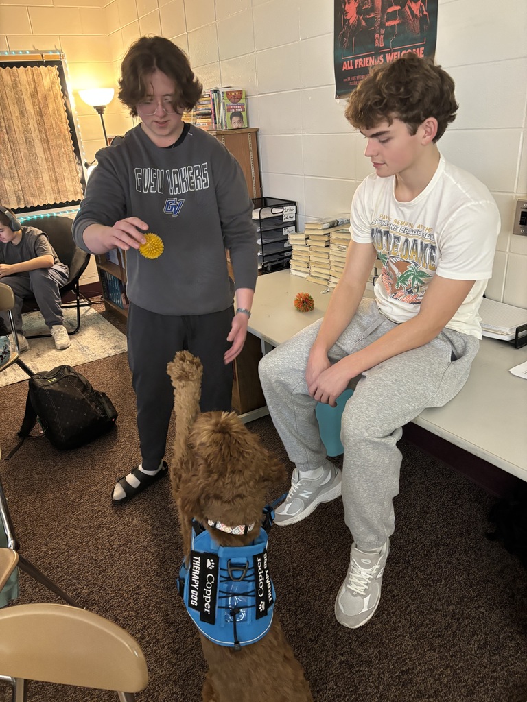 two kids giving copper his ball