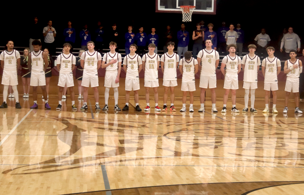 basketball players doing national anthem
