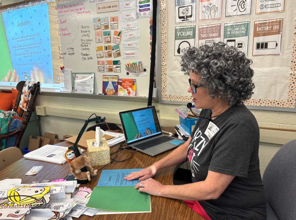 author reading book on screen