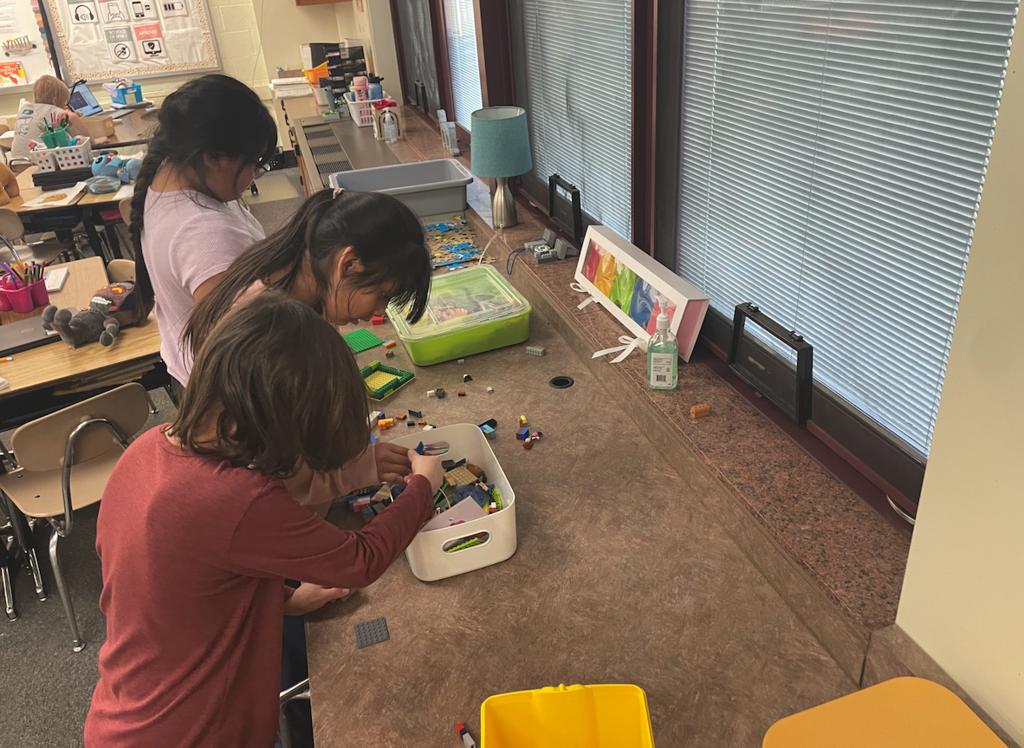 three kids playing with legos