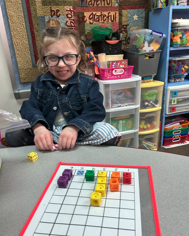 little girl making graphs smiling