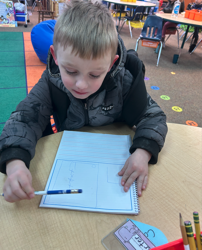 little boy look at notebook