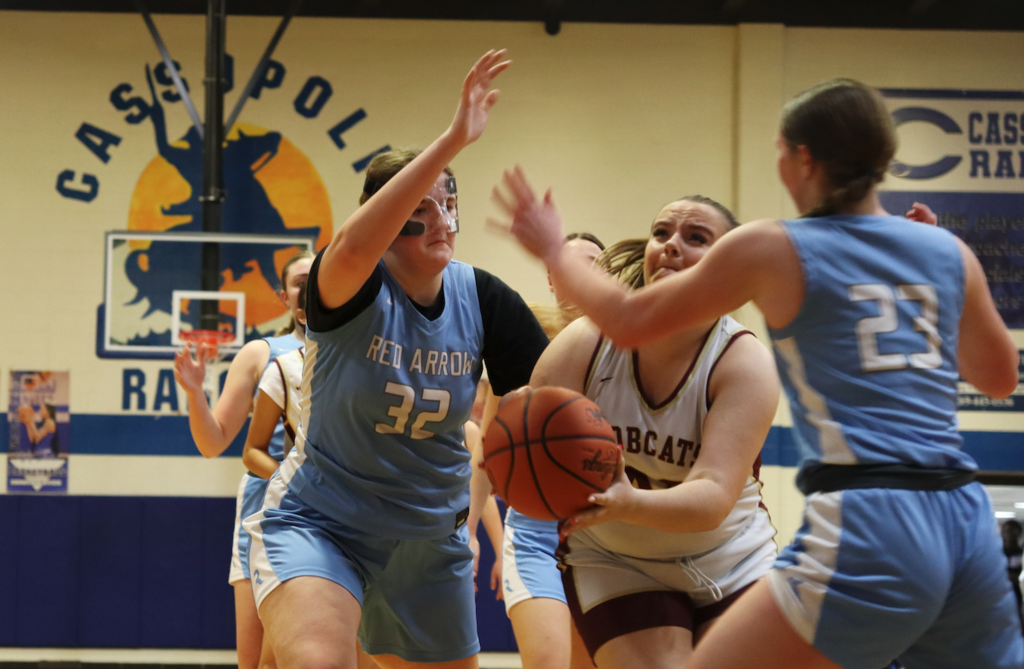 basketball players trying to make a basket