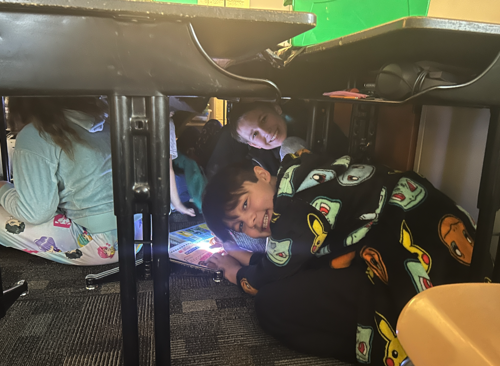  kids under desks reading