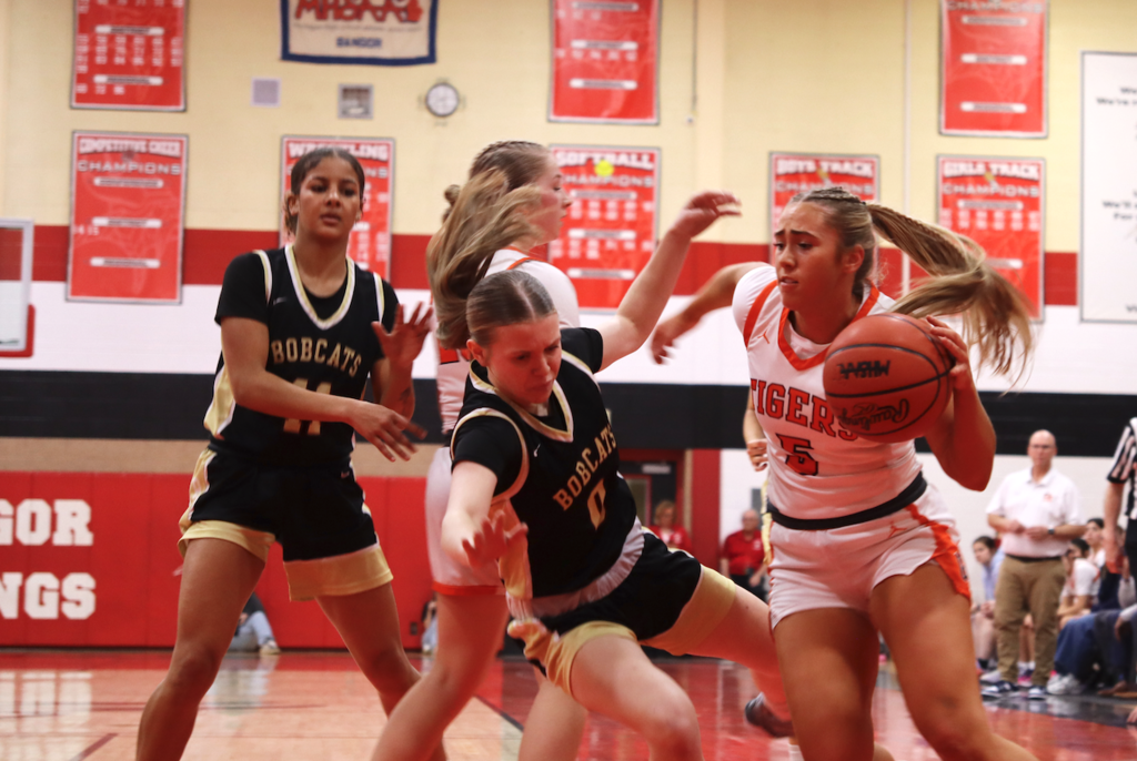 basketball player guarding player with ball
