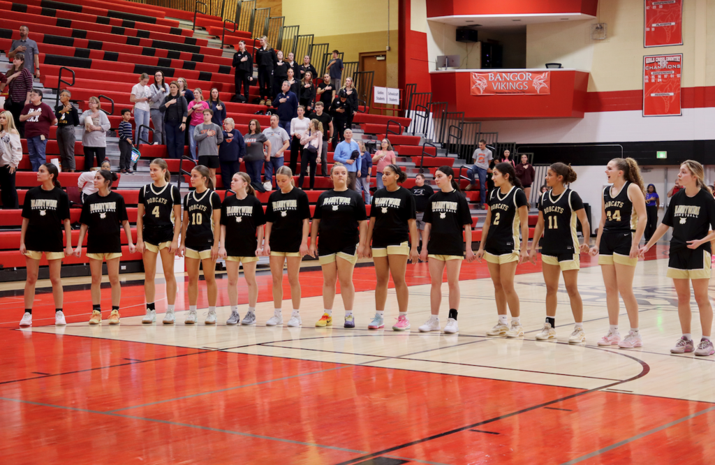 basketball players standing on the court