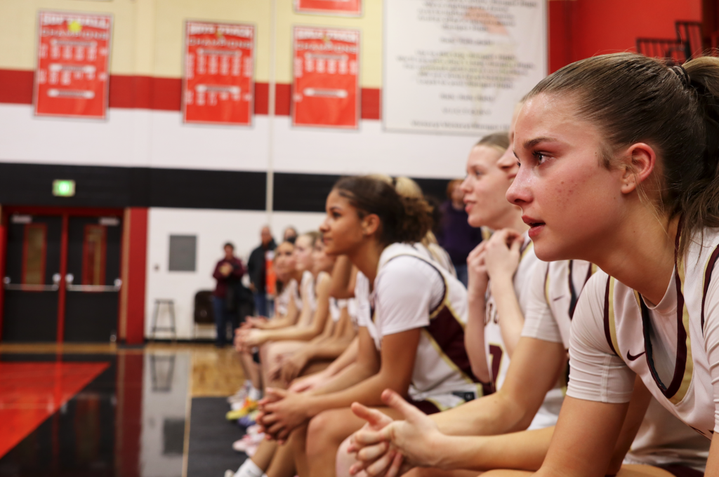basketball team sitting on bench