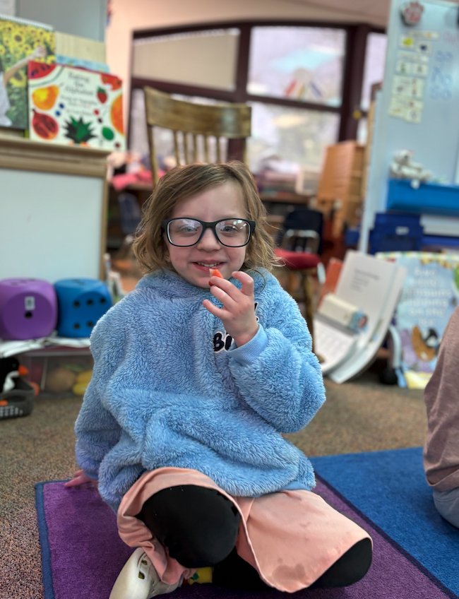 little girl trying strawberry