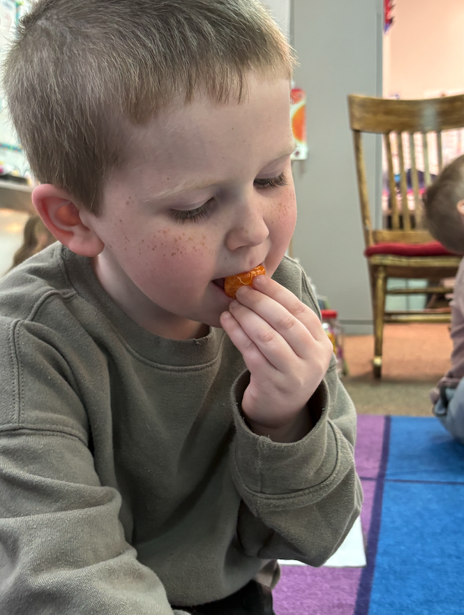 little boy trying fruit