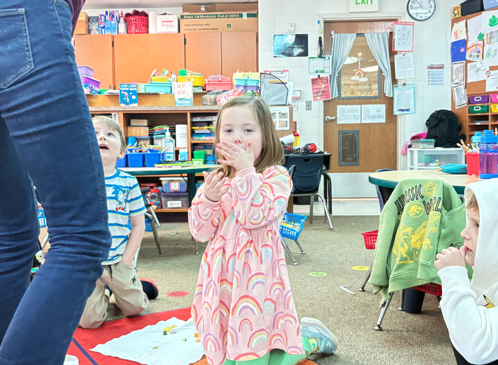 little girl eating veggie