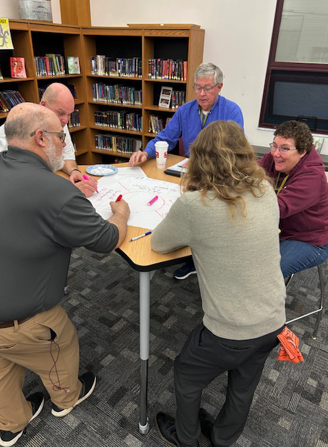 teachers working around table together