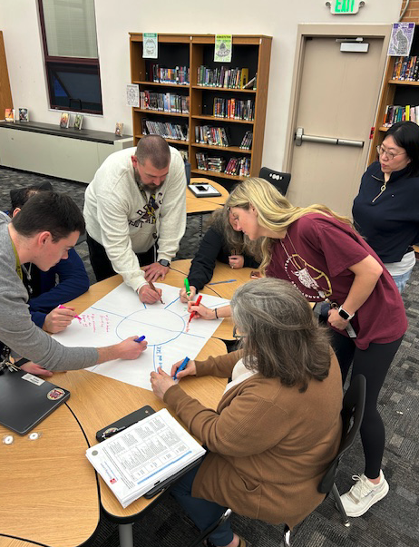 teachers working around table together