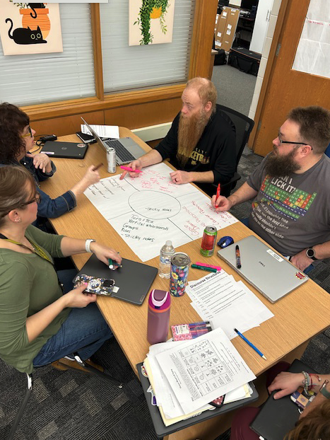 teachers working around table together