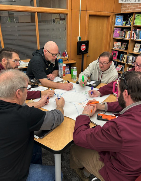 teachers working around table together
