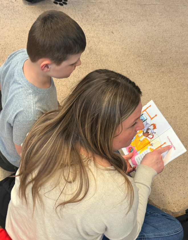 mom reading book to son