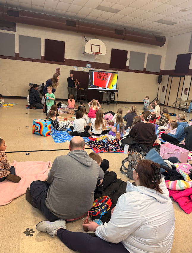 group of families in the gym on the floor
