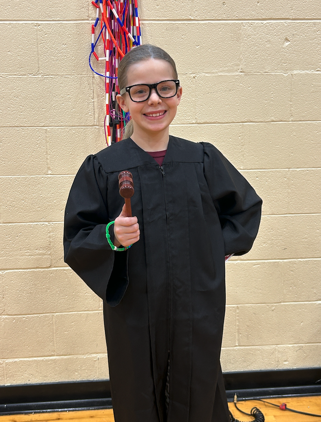kid dressed up  as judge for wax museum