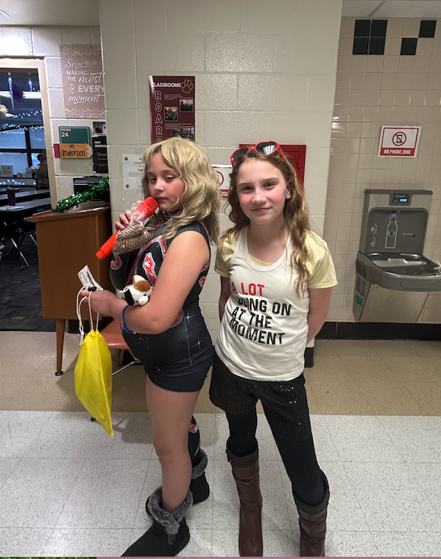 two girls dressed up like Taylor swift for wax museum