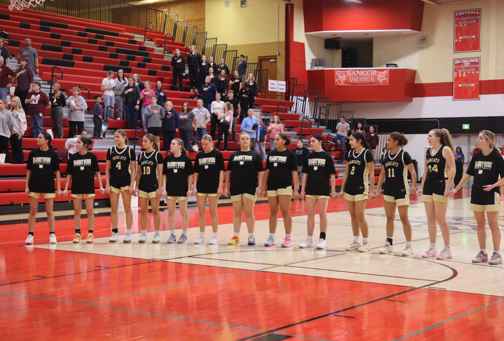 girls standing on court for national anthem