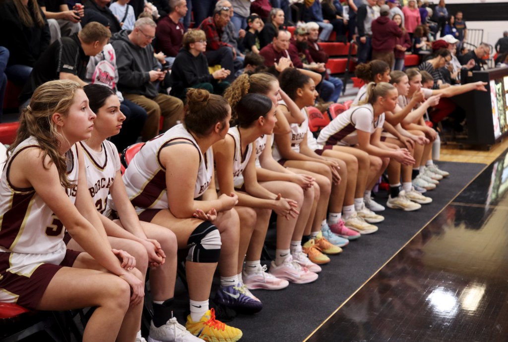 basketball players sitting on the bench