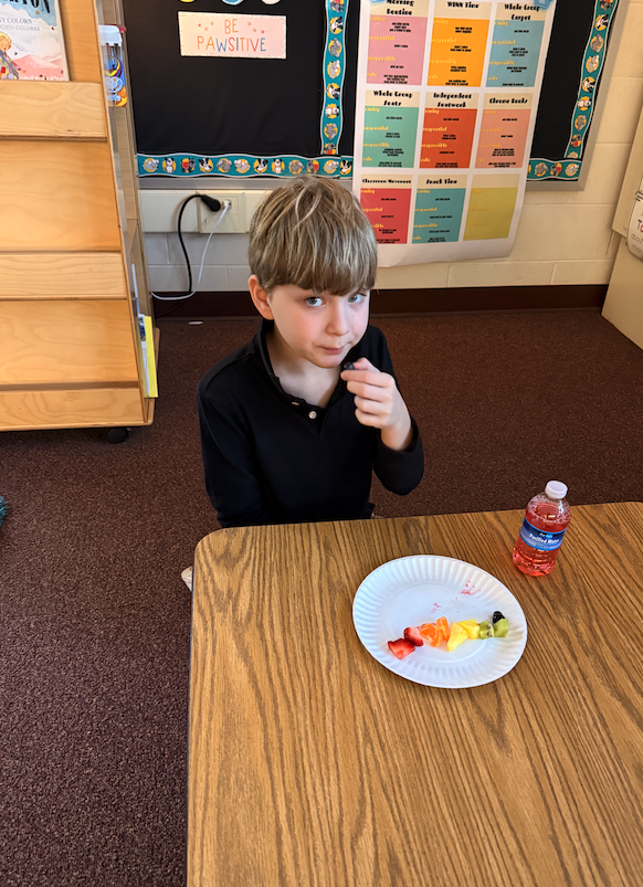 little boy eating fruits