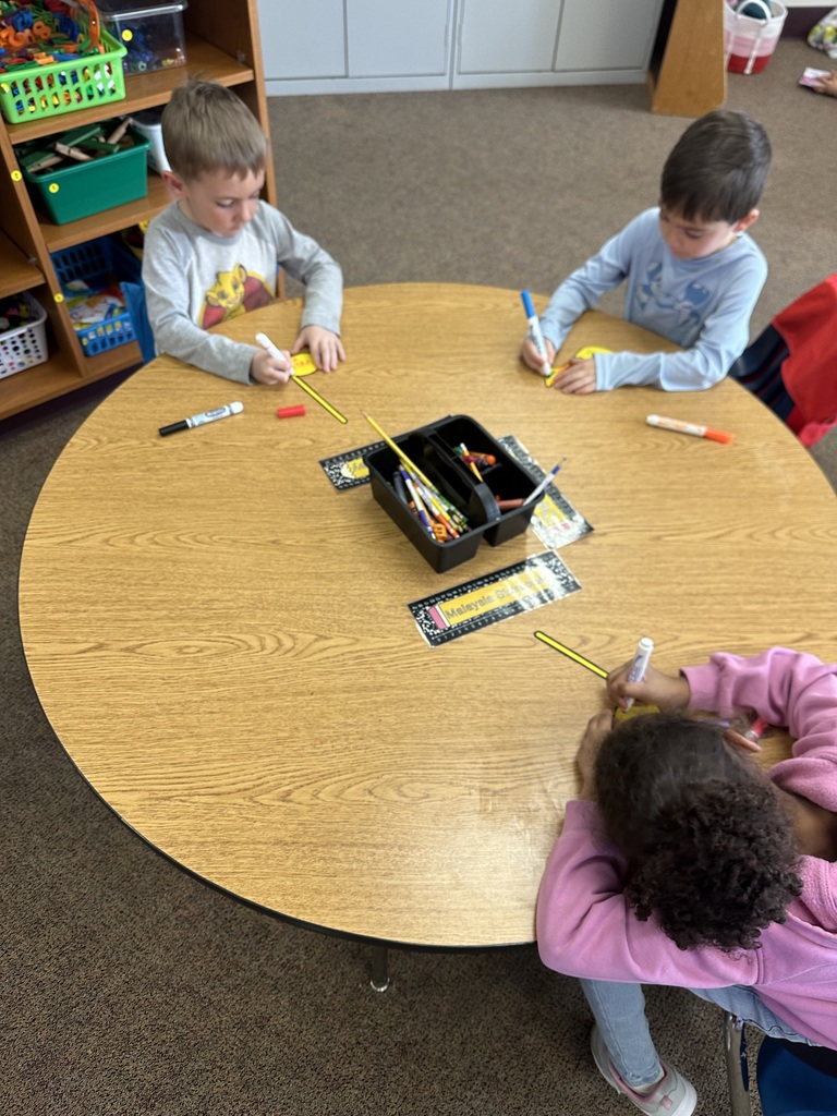 kids drawing at desk